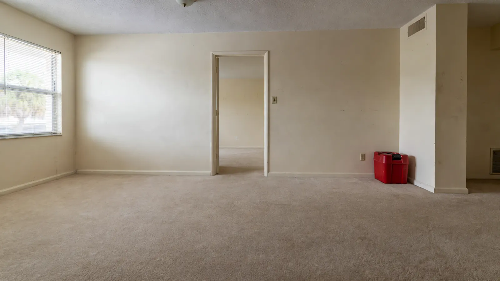 After: The same room restored with new carpet
