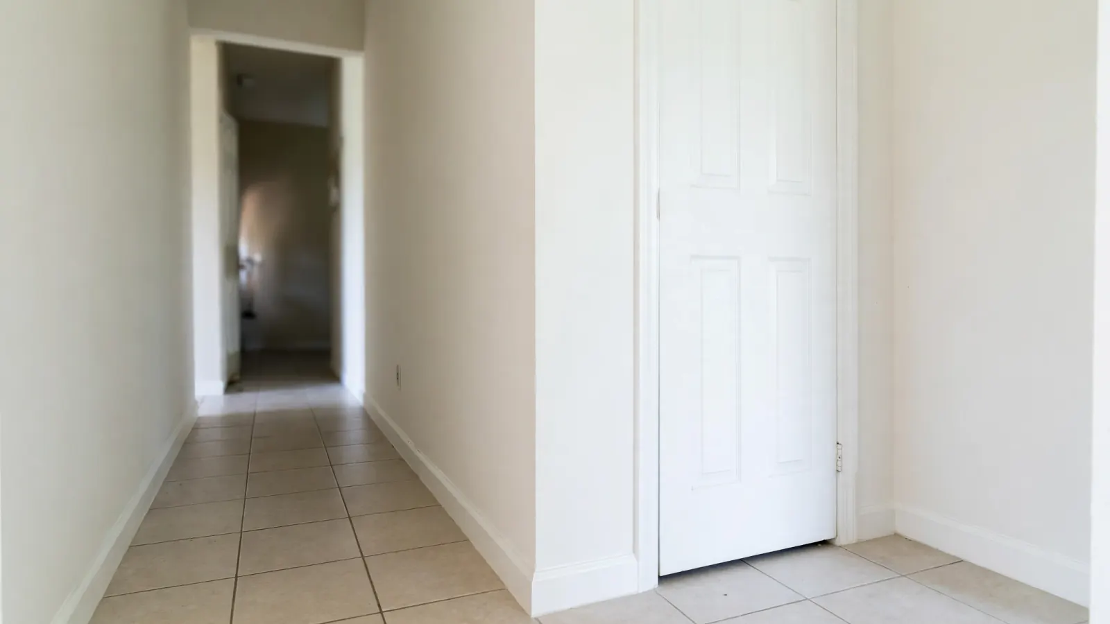 After: The same hallway with repaired white drywall