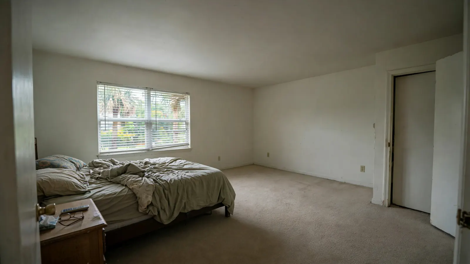 After: The same bedroom with a repaired, repainted ceiling