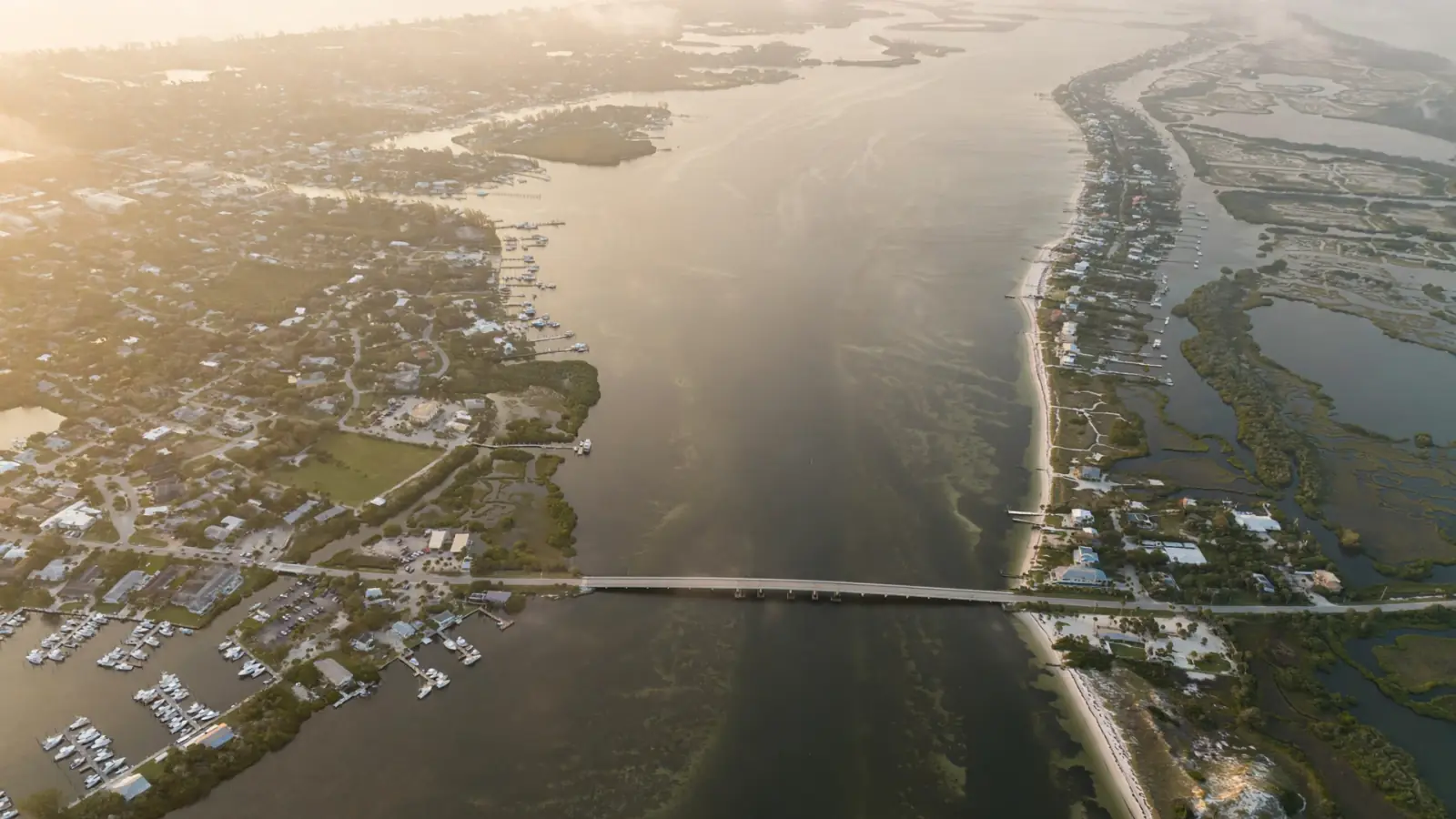 Aerial view of a lagoon, causeway and barrier island at sunrise